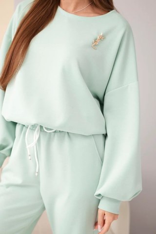 Komplet damski masełko bluza z broszką i spodnie z prostą nogawką ciemny miętowy